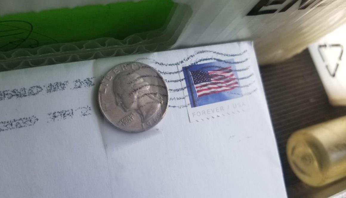 Coin taped to Envelope for mailing