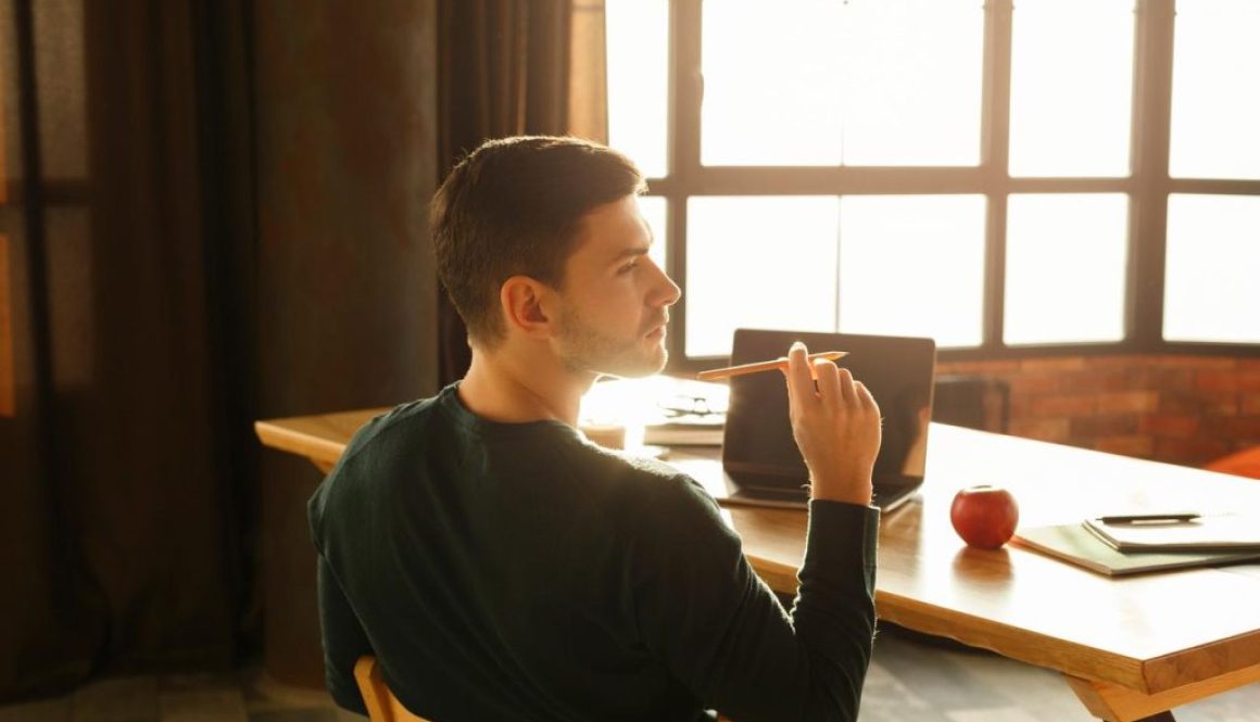 man thinking with pencil
